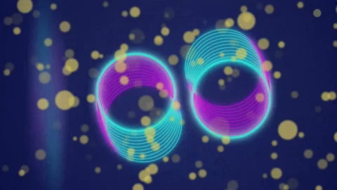 Animation of rotating pink and blue rings and falling yellow light spots on dark Stock Footage 313166124