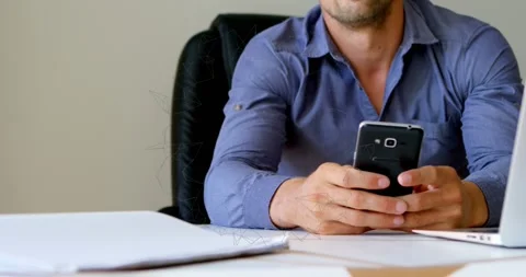 Animation of rotating shapes over midsection of caucasian man using smartphone Stock Footage 327582549