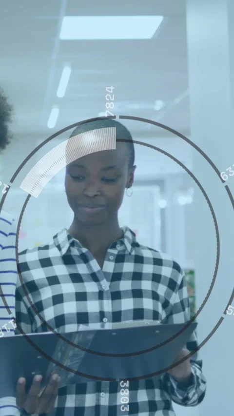 Animation of round scanner over two diverse female colleagues discussing while Stock Footage 343615560
