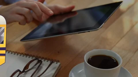 Animation of school bus icon over hands using tablet in office Stock Footage 329977532