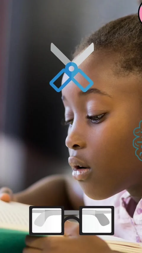 Animation of school icons scrolling over schoolgirl reading in class Stock Footage 342601502