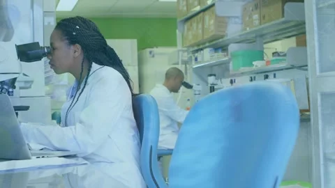 Animation of scientific data over african american female lab worker using Stock Footage 329412866