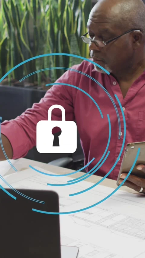 Animation of security padlock icon over african american man working on his plan Stock Footage 344595206