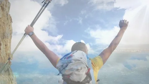 Animation of sky with clouds over caucasian man with arms outstretched hiking Stock Footage 192356441