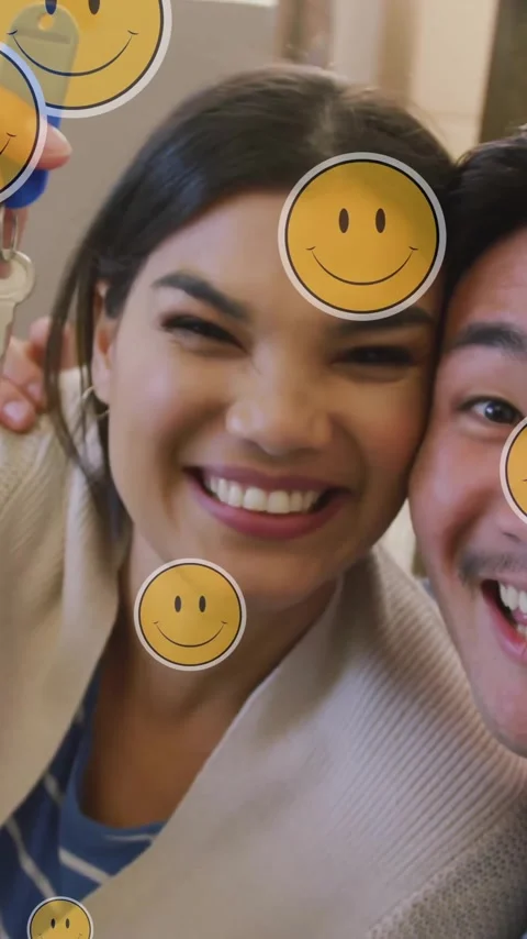Animation of smiley face icons over happy couple with house key Stock Footage 323781524