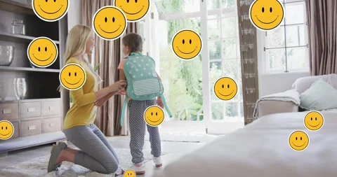 Animation of smiley faces over happy caucasian mother preparing daughter for Stock Footage 328706892