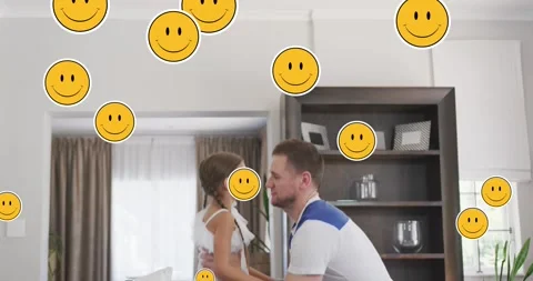 Animation of smiley faces over happy caucasian father and daughter jumping at Stock Footage 329157096