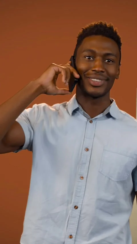 Animation of smiling man talking on smartphone with stacks of boxes on orange Stock Footage 342004163