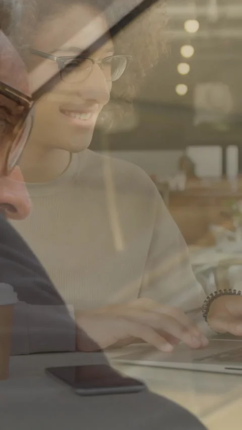 Animation of smiling woman using laptop in cafe, over brainstorming businessman Stock Footage 344706355