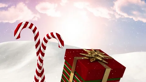 Animation of snow falling over christmas gift box and candy cane on winter Stock Footage 329850162