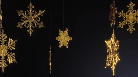 Animation of sparkling golden snowflakes hanging on threads Stock Footage