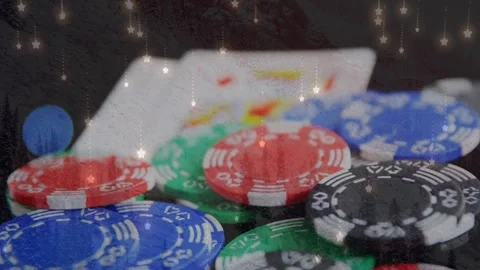 Animation of star icons falling over close up of playing cards and casino poker Stock Footage 328506647