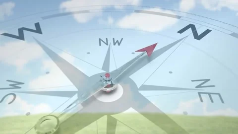 Animation starting, red compass needle pivoting SE to N, overlaying pasture to Video stock 321121250