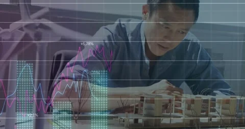 Animation of statistical data processing over asian male architect working on Stock Footage 326876473