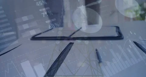 Animation of statistics and financial data processing over notebook on desk in Stock Footage 326625118