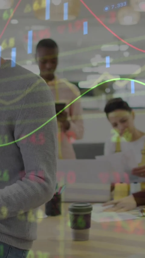 Animation of stock market data processing over diverse colleagues reading Stock Footage 320921866
