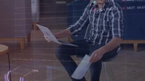 Animation of stock market data processing against caucasian man reading Stock Footage 328595320