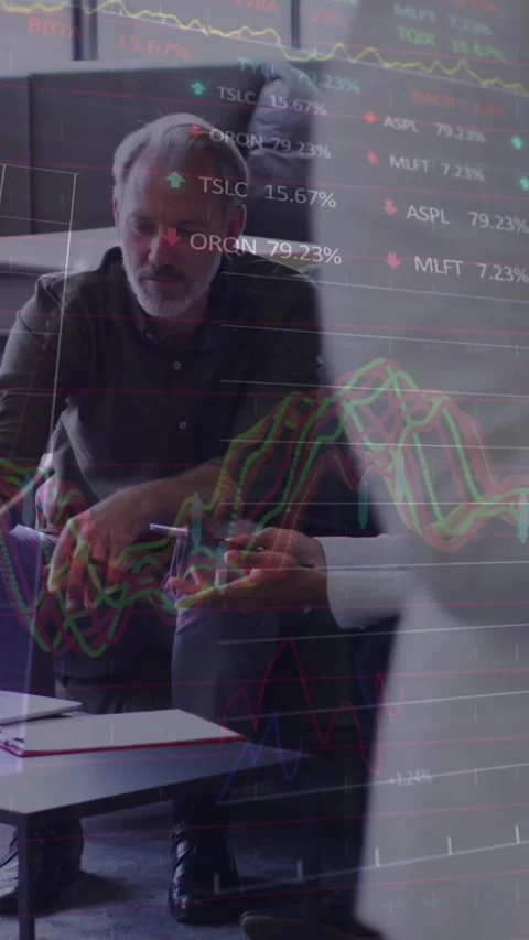 Animation of stock market data processing against two diverse men discussing Stock Footage 344706650