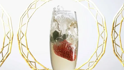 Animation of strawberry falling in champagne filled flue glass over abstract Stock Footage 327127727