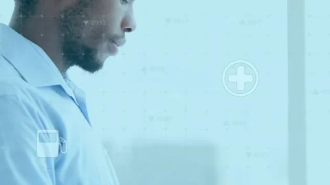 Animation of tech icons floating over african american man using tablet Stock Footage 326303172