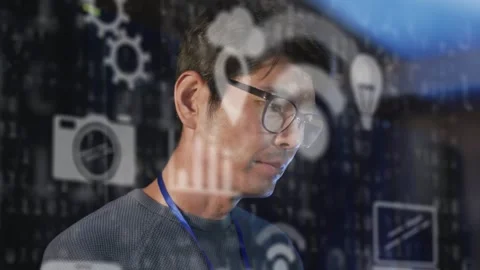 Animation of tech icons over asian man checking servers Stock Footage 328581921