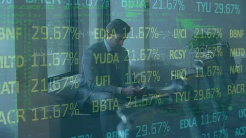 Animation of trading board, computer language on caucasian businessman using Stock Footage 326751929