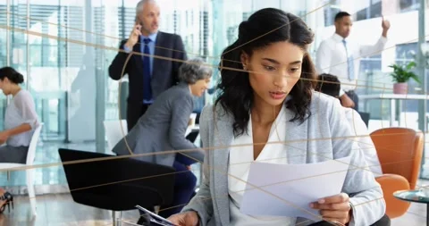 Animation of tunnel in seamless pattern over biracial businesswoman reading Stock Footage 229838233
