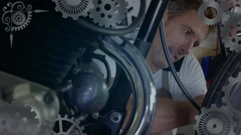 Animation of turning cogs over caucasian male mechanic fixing motorcycle and Stock Footage