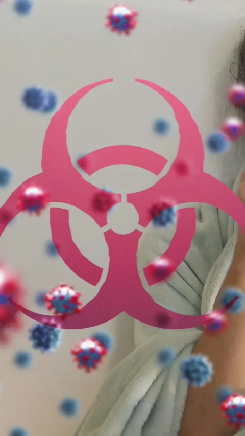 Animation of virus cells and biohazard symbol over caucasian woman lying in bed Stock-Footage 343644472
