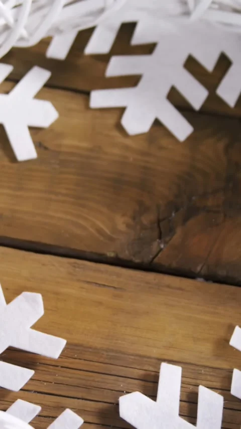 Animation of white crown and snowflakes shapes on wooden table at christmas Stock Footage 344723399