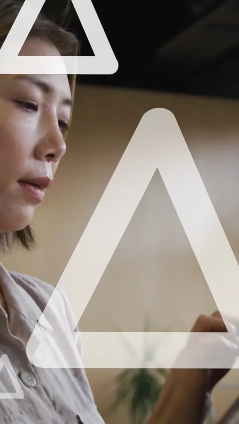 Animation of white triangles moving over asian businesswoman using digital Stock Footage 343615504