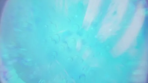 Animation zoom in macro move camera cream drop atom molecules flying into camera Video stock 168003822