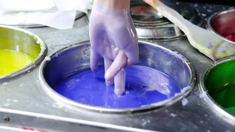 Animator dips a child's hand into paraffin Stock Footage 285778469