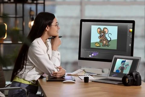Animator working with computer and laptop. Illustrations on screens Stock Photos