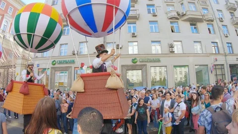Animators in baskets and balloons depicting a balloon on stilts Video stock 116770534