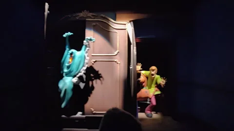 Animatronic Ghost Surprises Scooby-Doo Characters in Dark Museum Ride at Warner Stock Footage 346303592