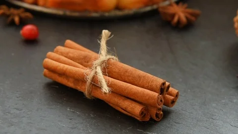 Anise, cinnamon, cranberries on black table Video stock 70437475