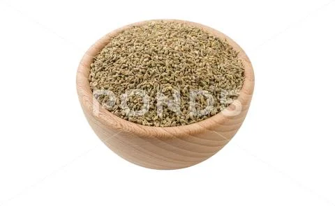 Anise seeds in wooden bowl isolated on white background. 45 degree view. Spic Stock Photos