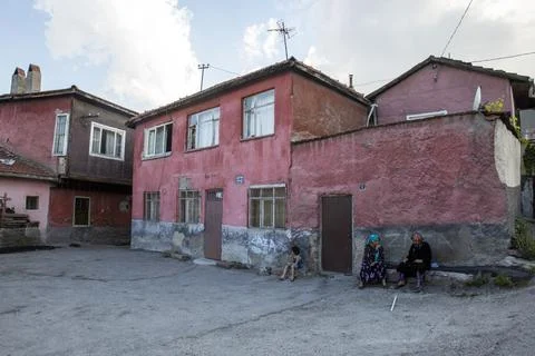 Ankara, Turkey - 13 Jun 2022:Two women rest by the roadside, one in pink, f.. Stock Photos