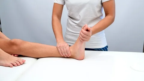 Ankle physiotherapy to a boy Stock Footage 98795708
