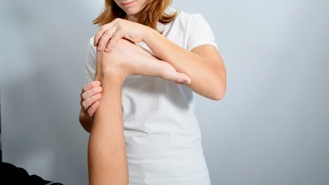 Ankle physiotherapy to a boy Stock Footage 98796933