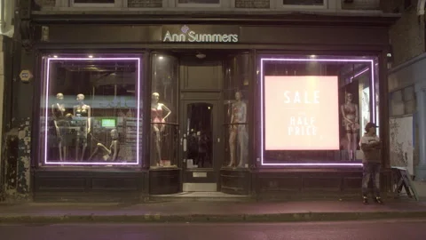 Ann Summers Lingerie Storefront at Night with Pedestrians Stock Footage 344619092