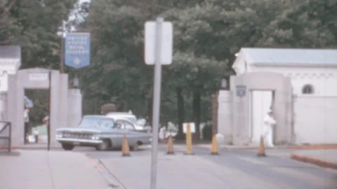 Annapolis - 1963: US Naval Academy flag and entrance while car leaves Stock Footage 258324580