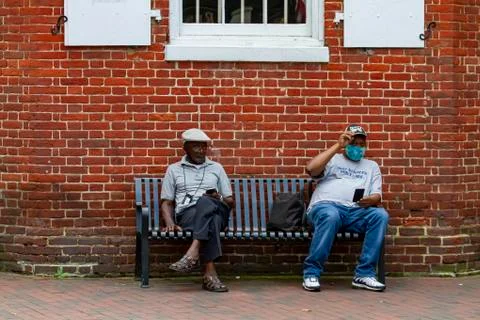 Annapolis, MD 08/21/2020: Two elderly African American men sitting on a bench Stock Photos