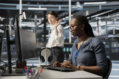 Annoyed data center engineer leaving after having fight with coworker Stock Photos