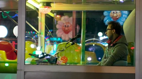 Annoyed Man in Carousel Ticket Booth Stock Footage 121549922