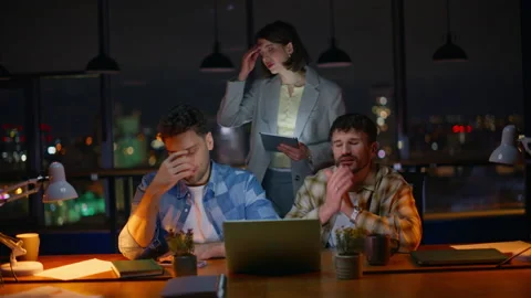 Annoyed startupers looking computer screen worried problem at overtime office Stock Footage 339299679