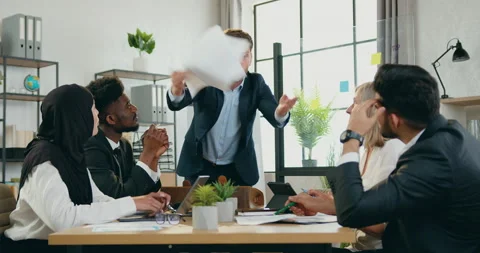 Annoyed stressed bearded chief scattering financial reports on the table behind Stock Footage 159595970