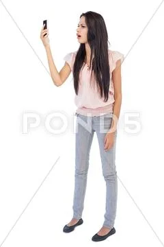 Annoyed woman looking at her cellphone Stock Photos