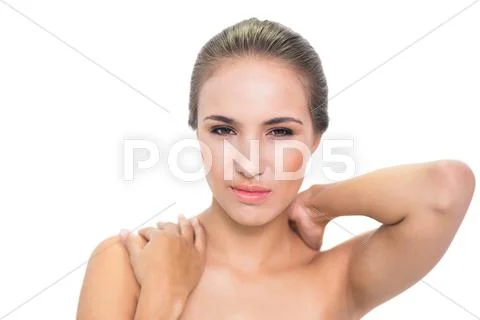 Annoyed young brunette woman suffering a sore neck Stock Photos